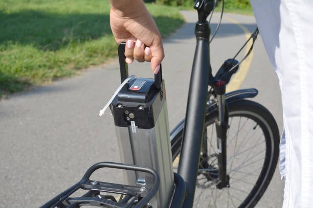 man taking e-bike battery outside of the frame