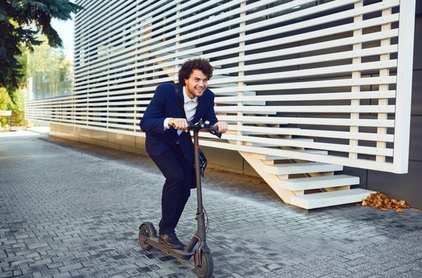 man riding e-scooter in the city